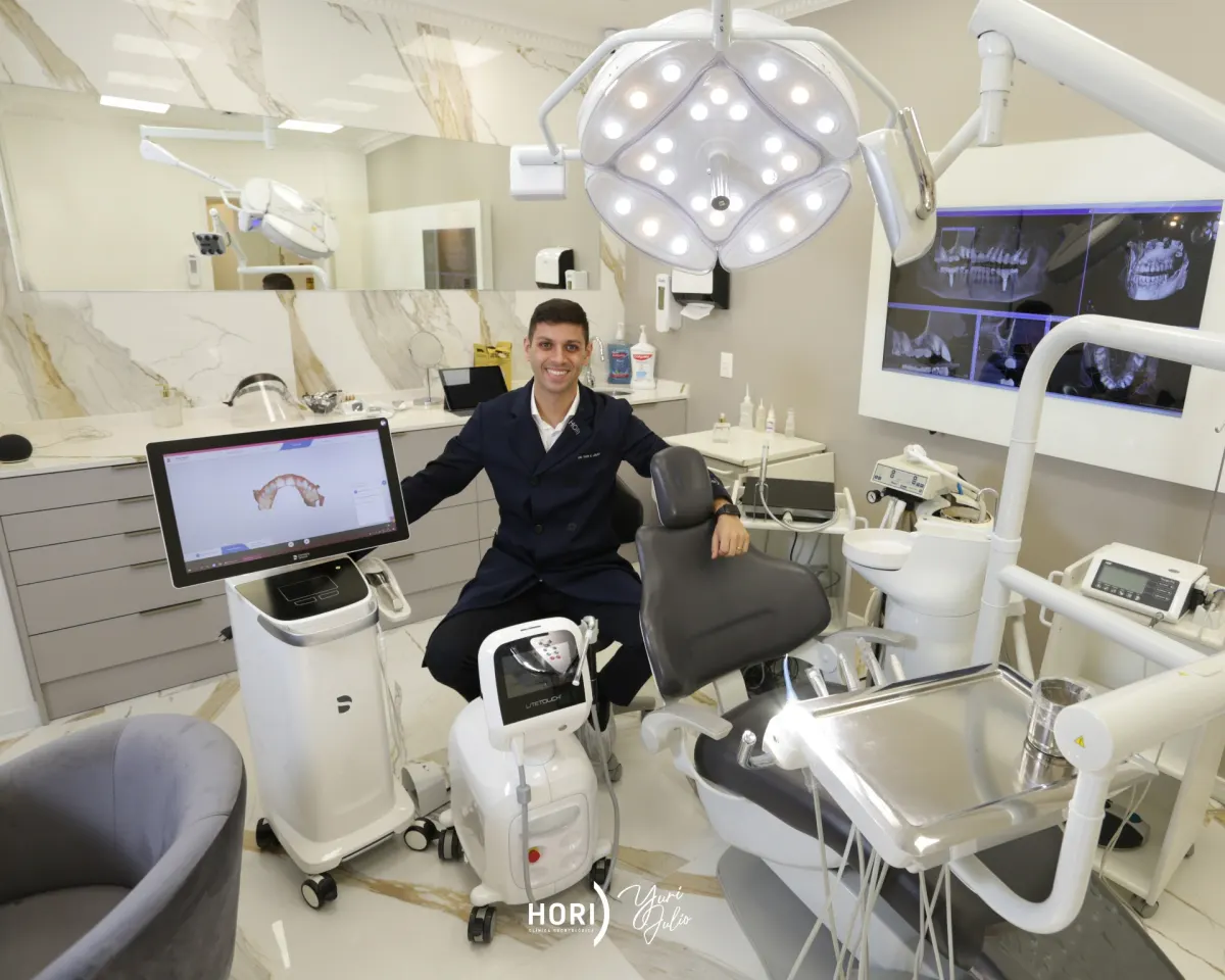 Dr. Yuri Julio reviewing information in a clinical setting for oral and maxillofacial treatment planning